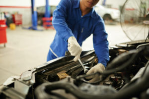 car mechanic examining transmission