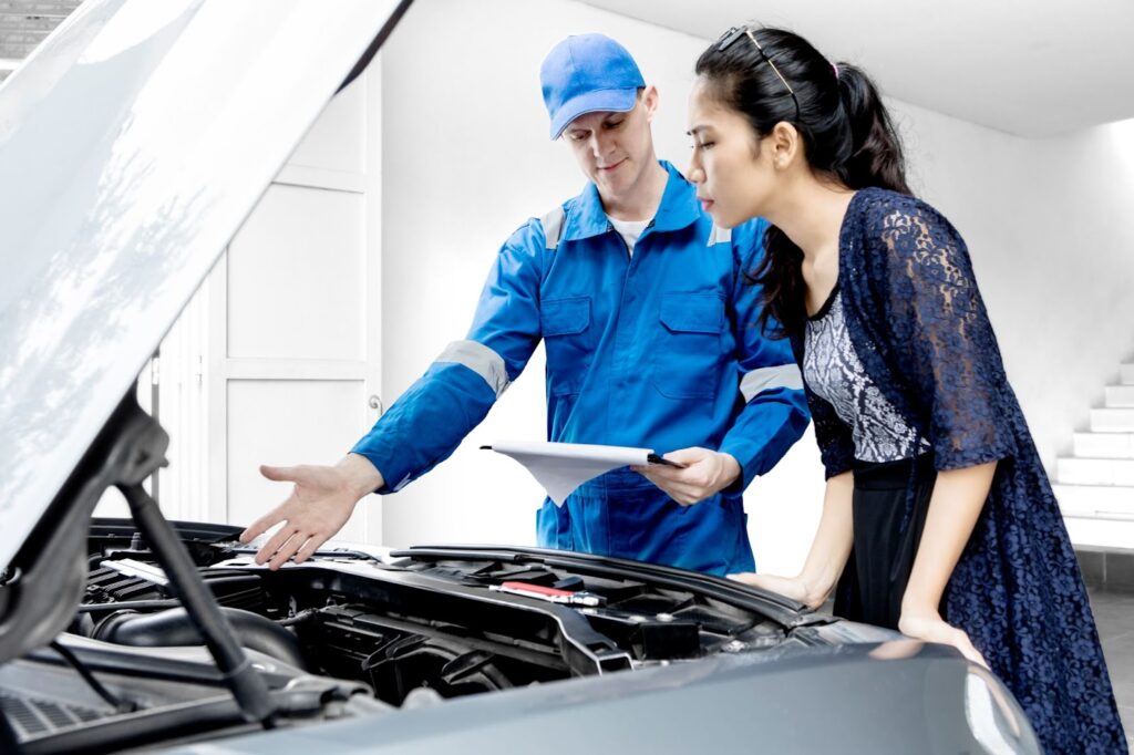 discussing auto repair with mechanic